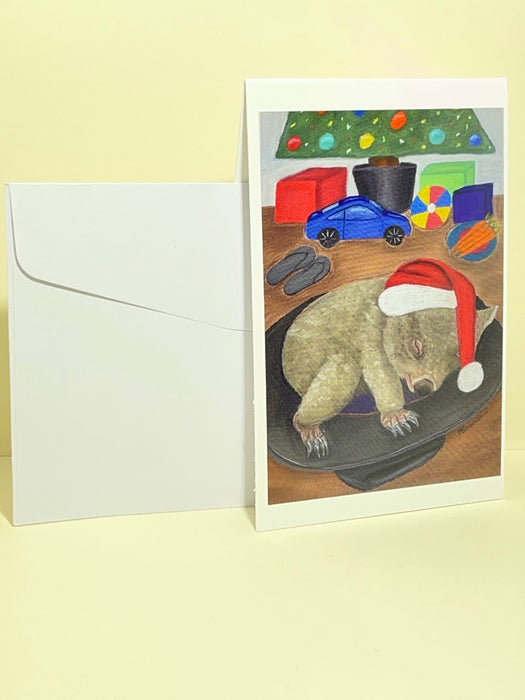 Mini Blank Christmas Card. Pastel Drawing of a Wombat Sleeping in an Akubra Hat.